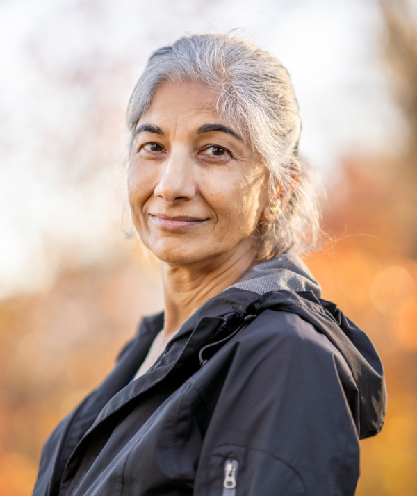 Smiling older woman outside at sunset