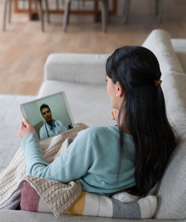 Woman on tablet talking to doctor virtually